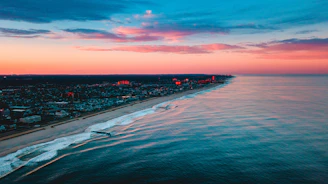 Aerial shot of a vibrant coastline at sunset, capturing the essence of travel documentaries.