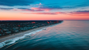 A stunning aerial shot of the Normandy coastline at sunset with vibrant colors.