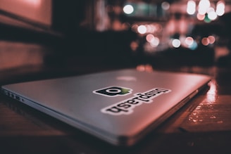 Close-up of a personalized vinyl sticker applied smoothly on a laptop cover