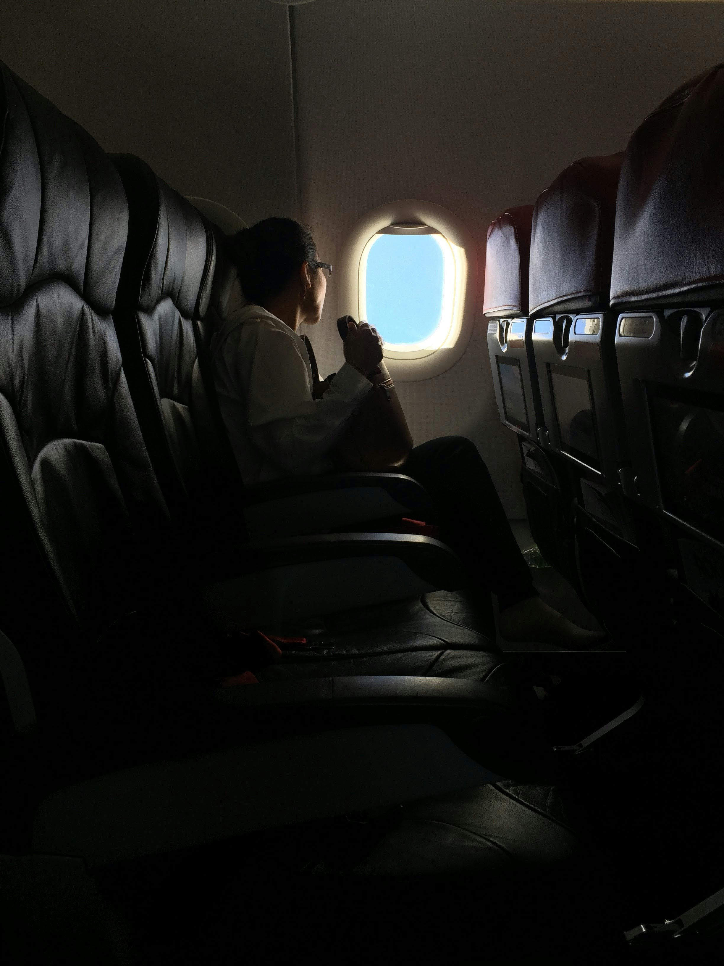 I was on my way to Jakarta from Kuala Lumpur, and this picture is captured when the flight is almost reached the metropolis city. This woman was sitting alone and the natural lighting that went into flight made me quickly grab my phone to snap this. I love natural lighting cause it will always create beautiful moments.