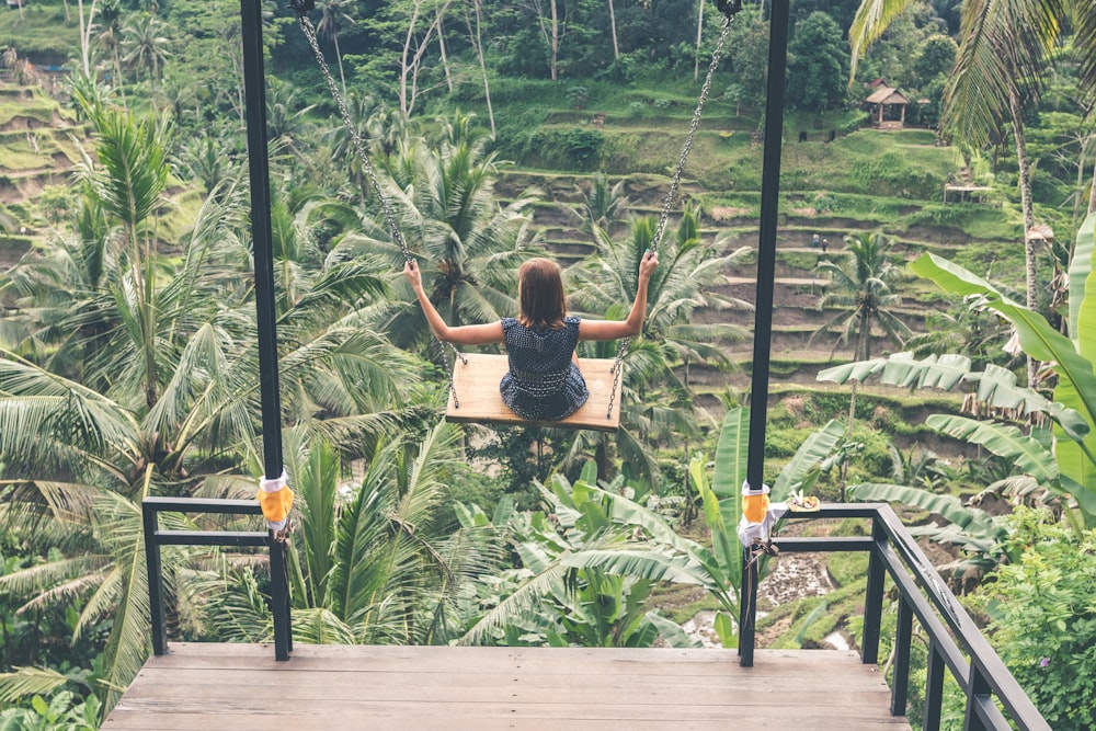 photograph of girl in swing