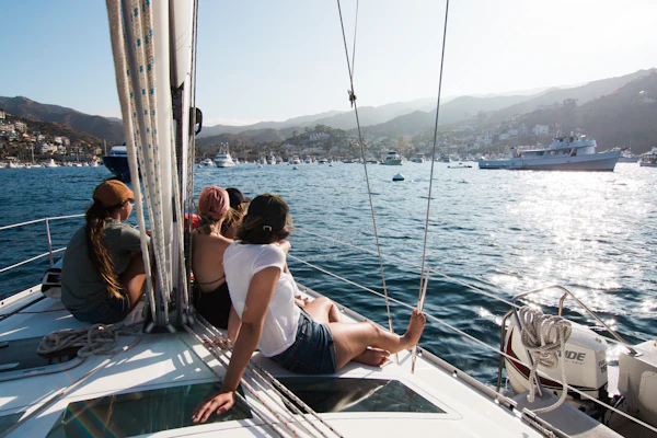 Friends relaxing together on a sailboat deck in the marina