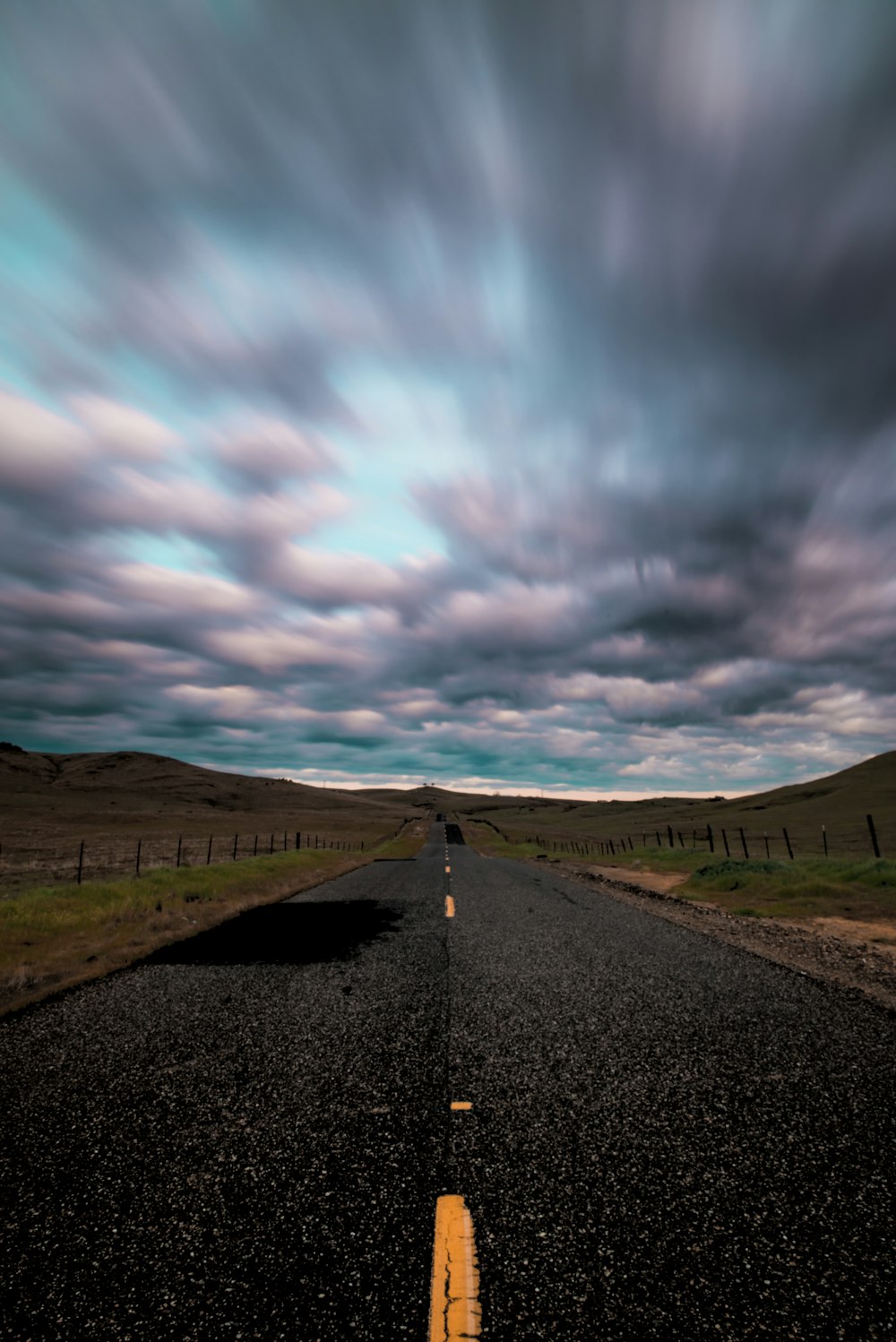 empty concrete road under blue sky