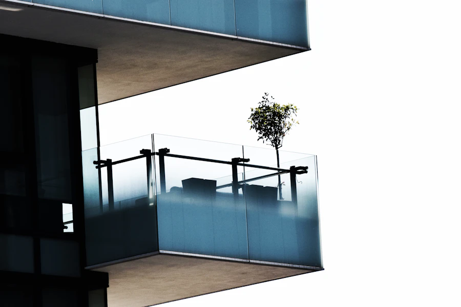 Glass staircase balustrade with clean stainless steel handrail in a bright architectural interior