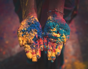 closeup photo of person holding color soils