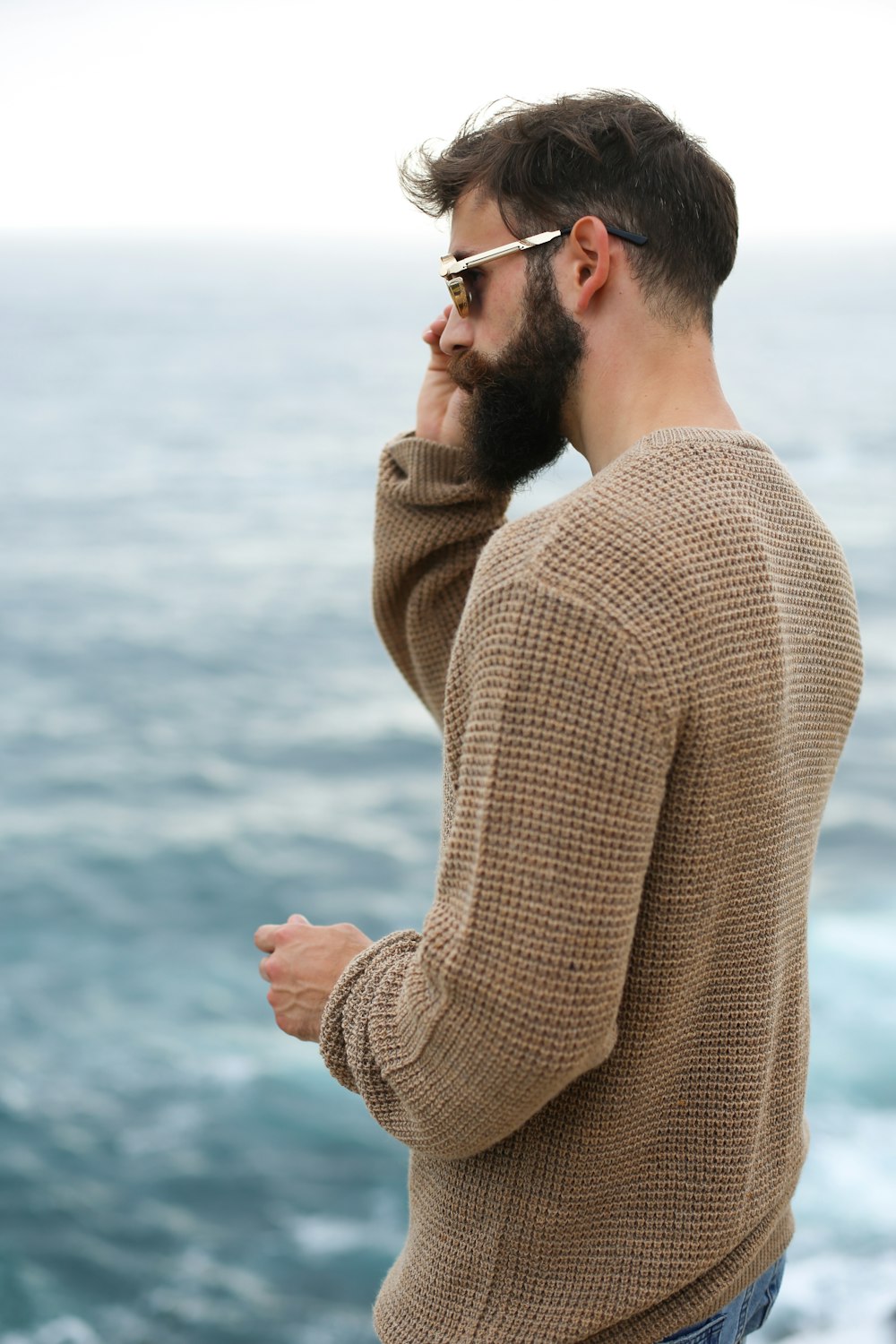 man holding his sunglasses