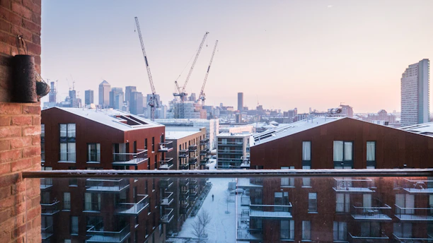 Cozy downtown apartment with balcony and city skyline views during the day.