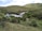 A serene landscape with gentle rain falling on lush greenery.