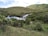A serene landscape with gentle rain falling on lush greenery.