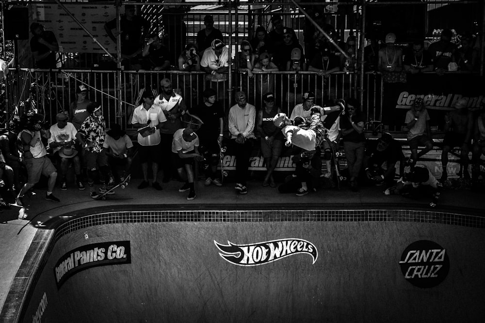 people sitting beside skateboard ramp