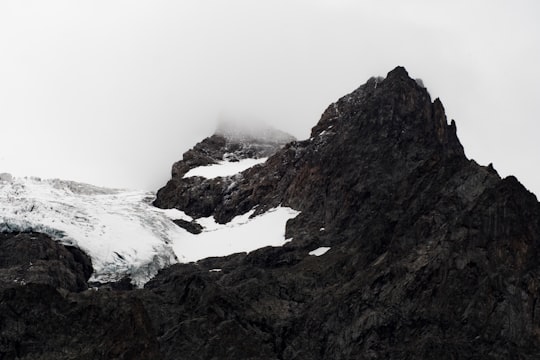 black mountains covered with snow in Meije France