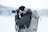 man standing on snow field while taking photo
