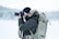 man standing on snow field while taking photo