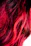 Close-up of a vibrant, freshly colored hair strand glowing under soft light.