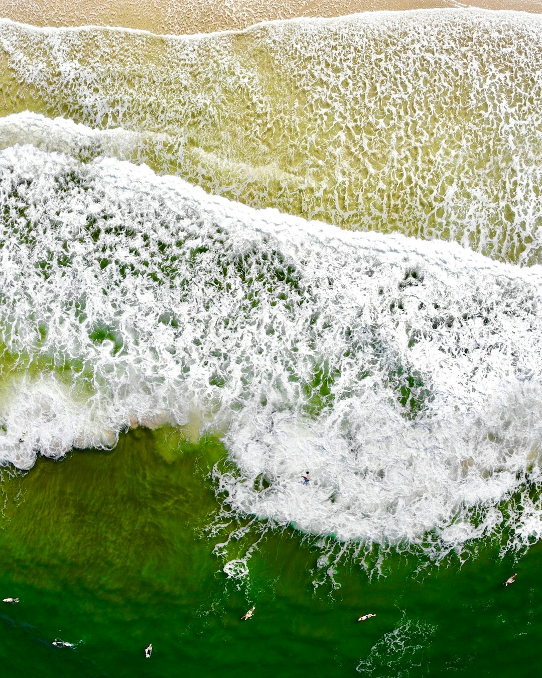 body of water waving on seashore