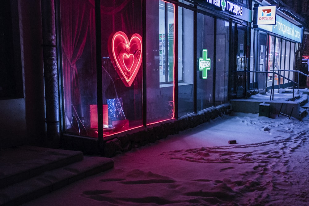 red and green neon light signages on building at nighttime