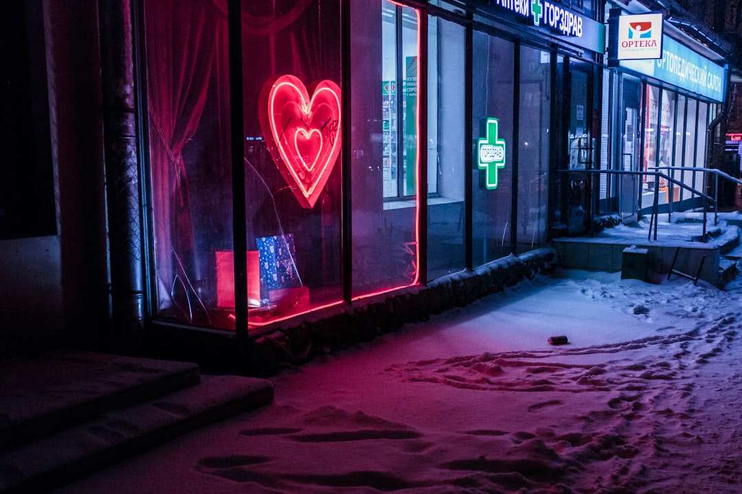 red and green neon light signages on building at nighttime