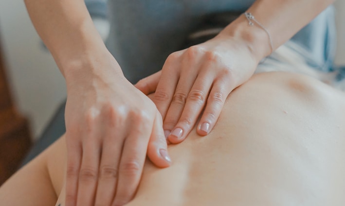 man massaging woman's body