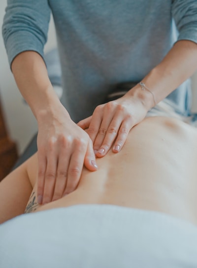 man massaging woman's body