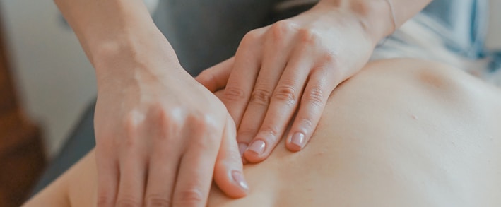 man massaging woman's body