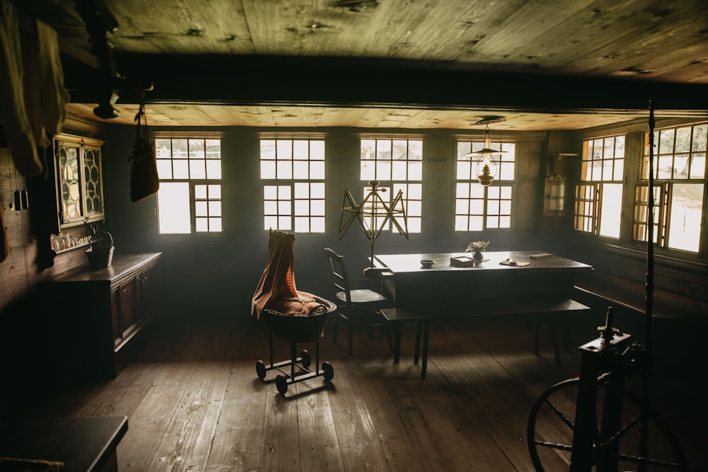 rectangular brown wooden table near chair and window