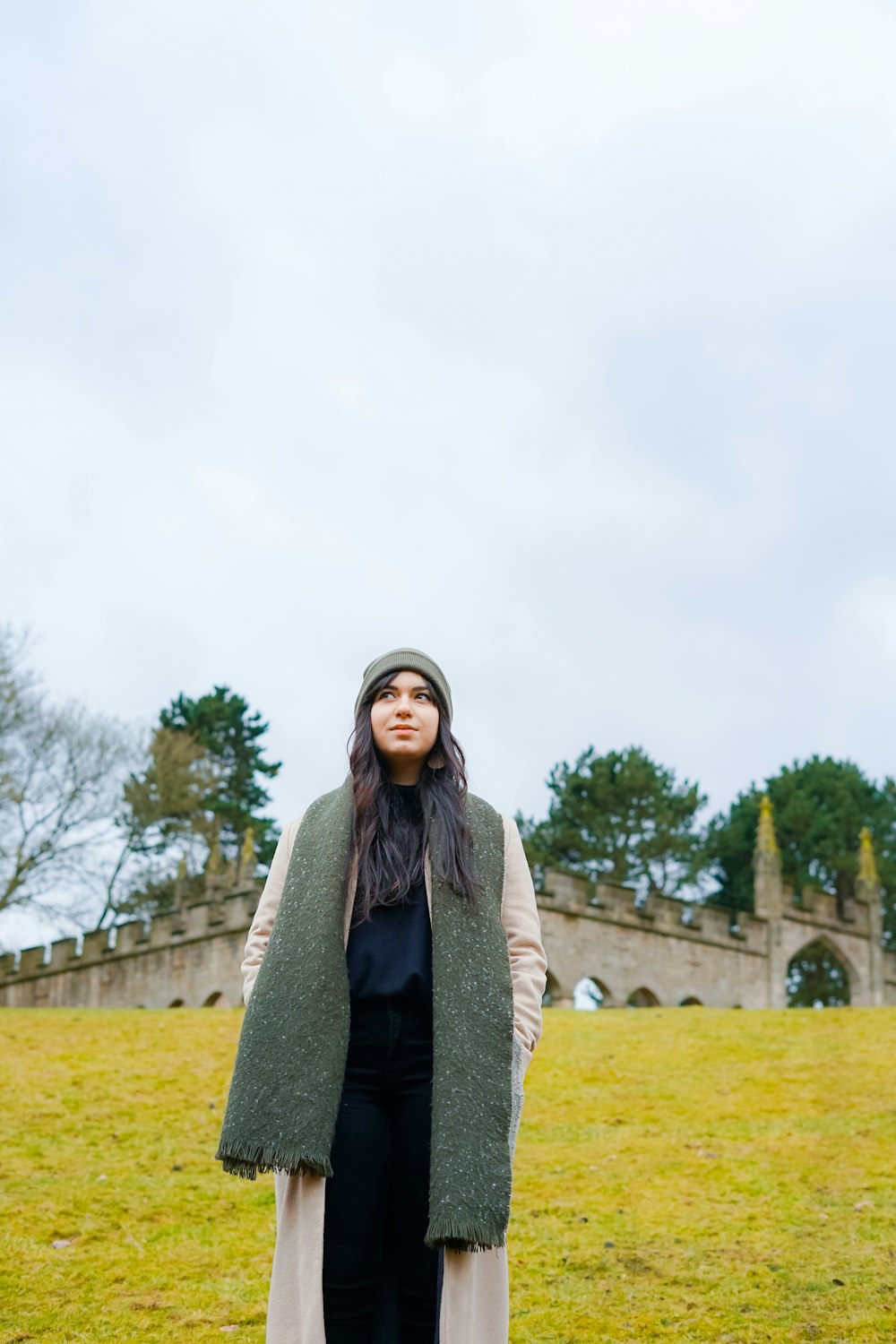 woman standing looking up near castle