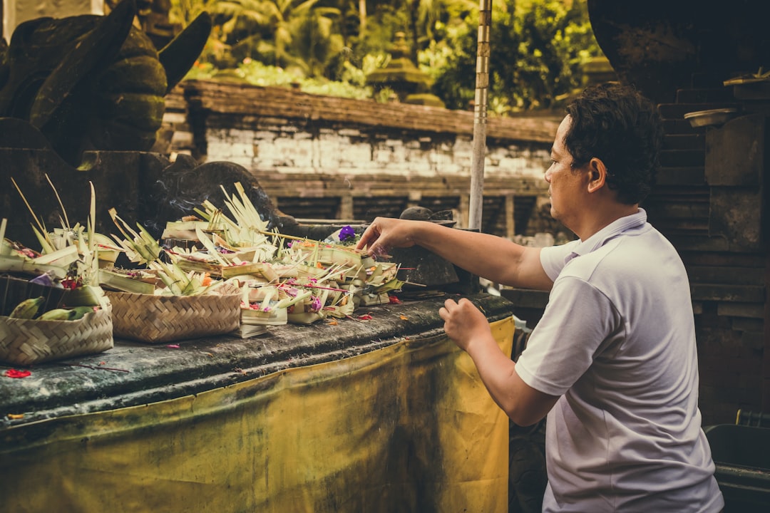 man standing holding flower during daytime