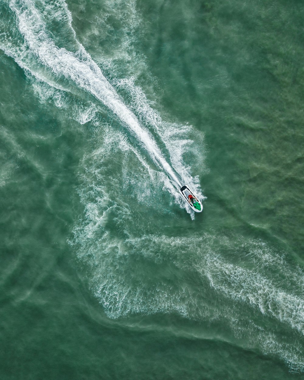 bird's eye view of personal watercraft on body of water