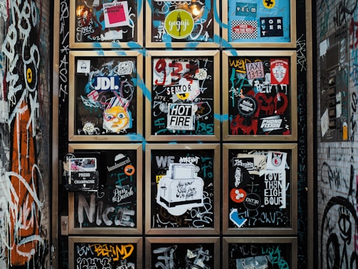 a wall covered in lots of different types of stickers