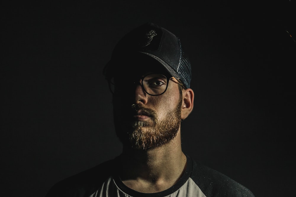 man wearing black cup and white and black crew-neck top