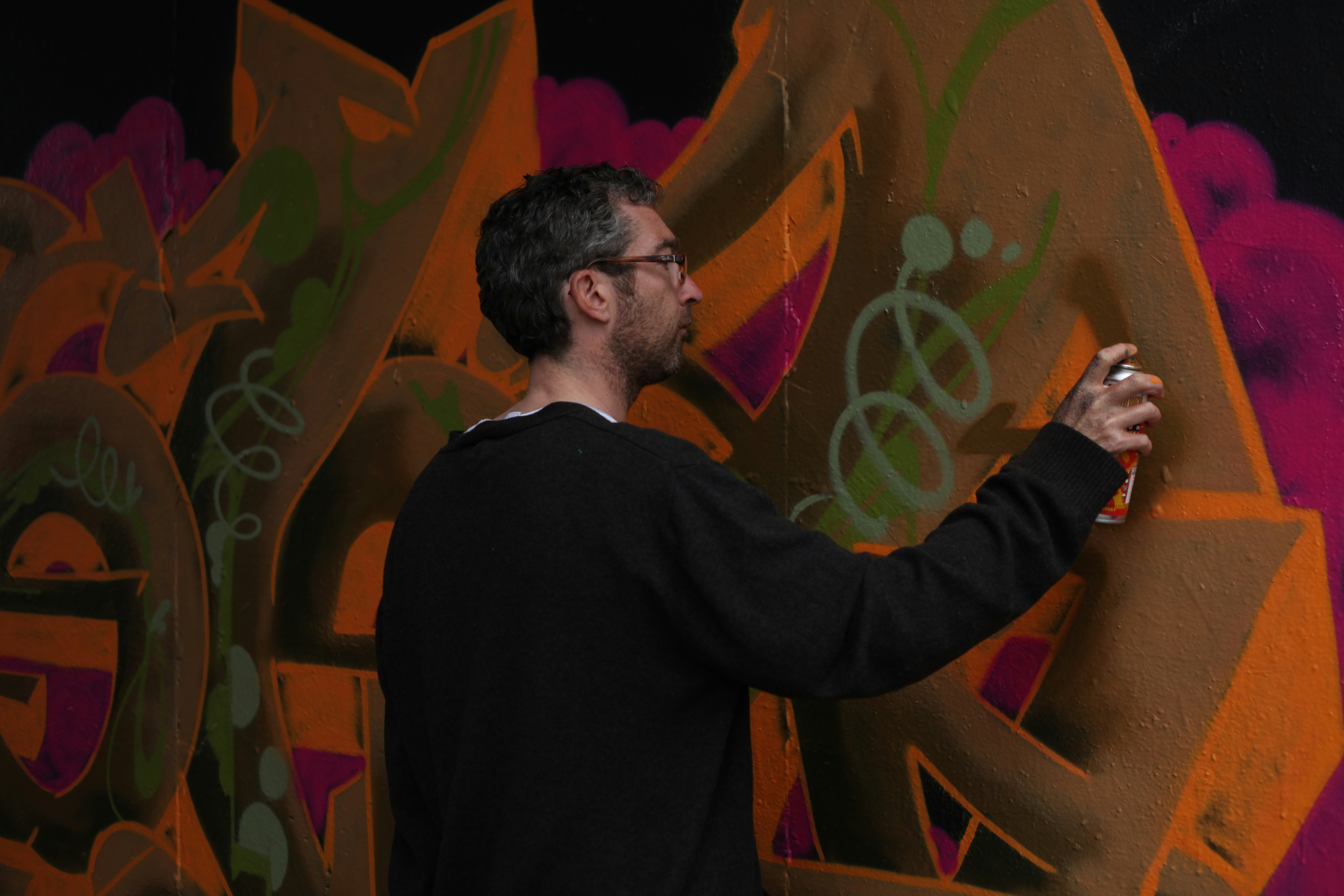 man holding holding paint can