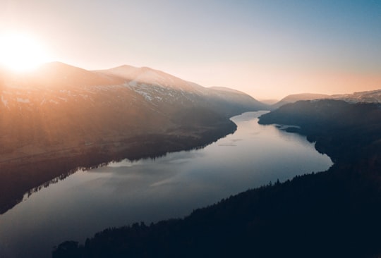 lake between trees and mountains in Raven Crag United Kingdom