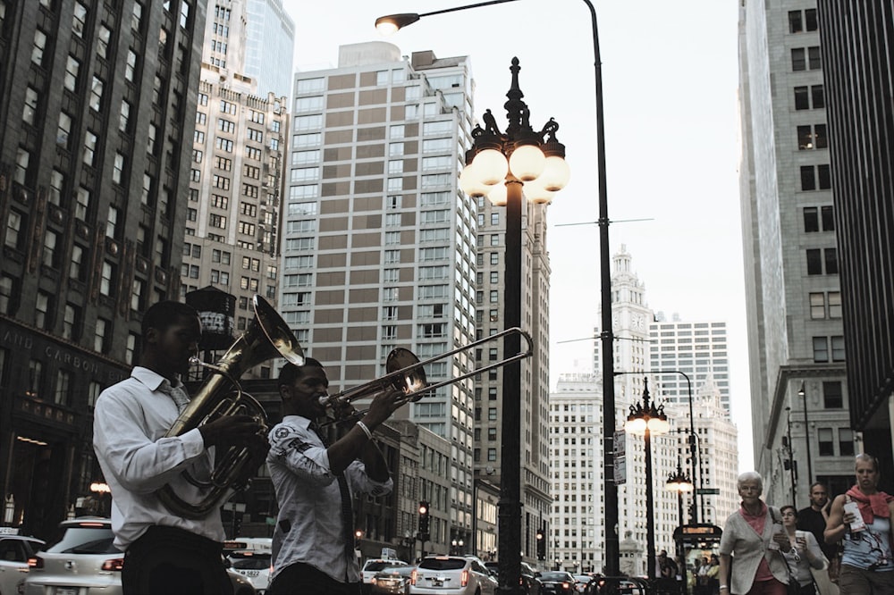 men's playing instruments on road