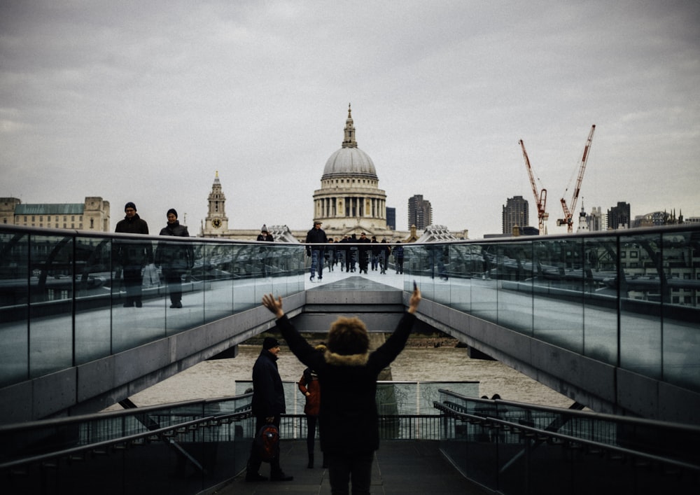 woman standing and raising her hands