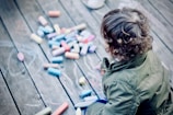 person sitting in front of assorted-color pens
