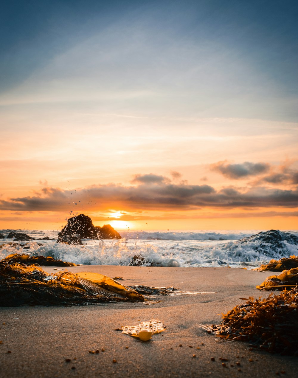 ocean smashed to sand during golden hour