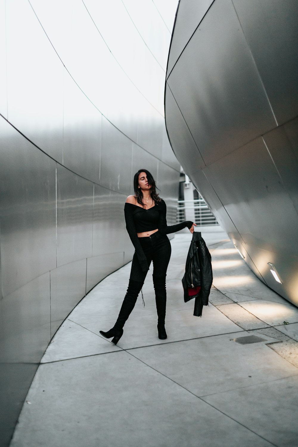 woman holding her jacket beside hall