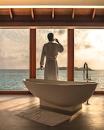 man standing beside bathtub