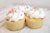 three cupcakes on white wood