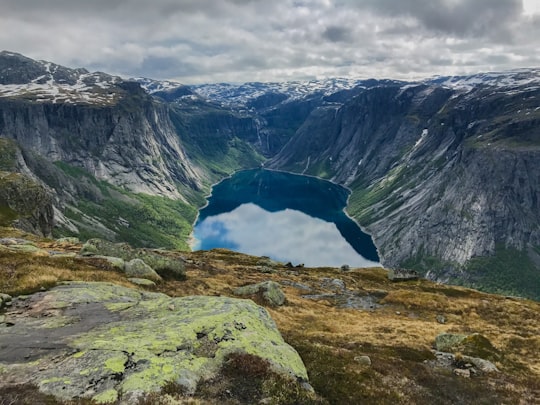 landscape photography of lake in Old Trolltunga Starting Point Norway