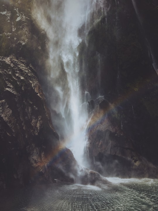 rainbow near the waterfalls in Milford Sound New Zealand