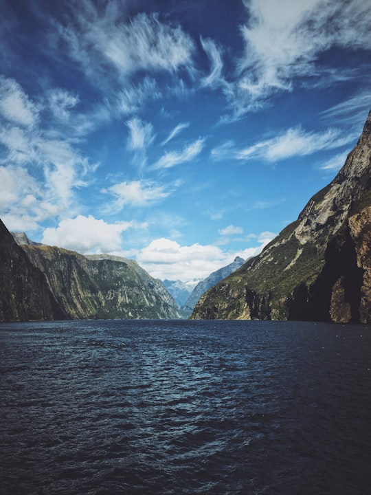 landscape photography of body of water between mountain range in Milford Sound New Zealand