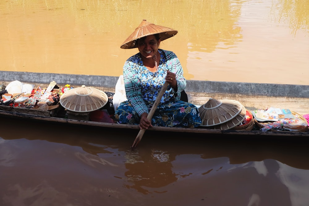 woman rowing boat on body of water