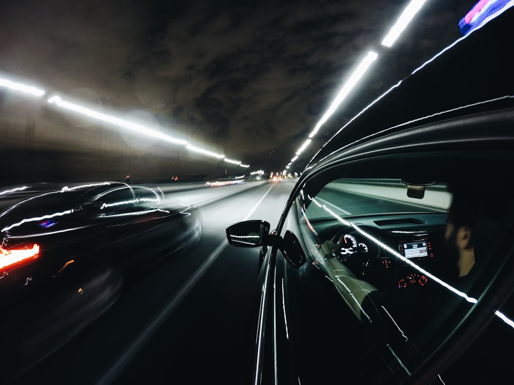 close-up photo of black car inside tunnel