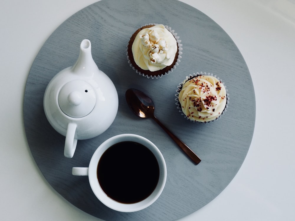 white ceramic teapot beside brown spoon