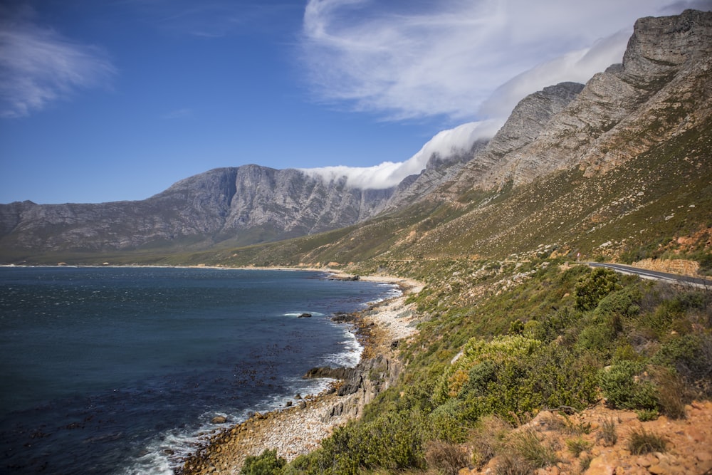 a scenic view of a mountain and a body of water