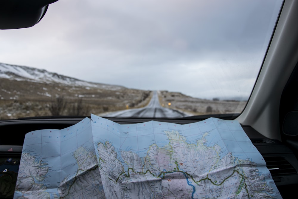 A person holding road map in car.