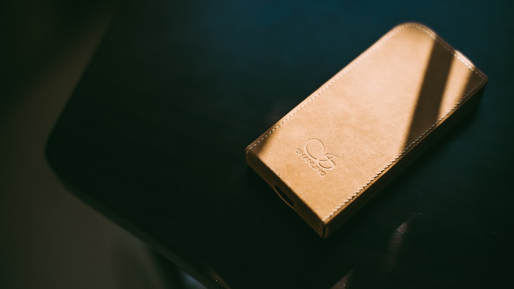 gold leather wallet on tabletop