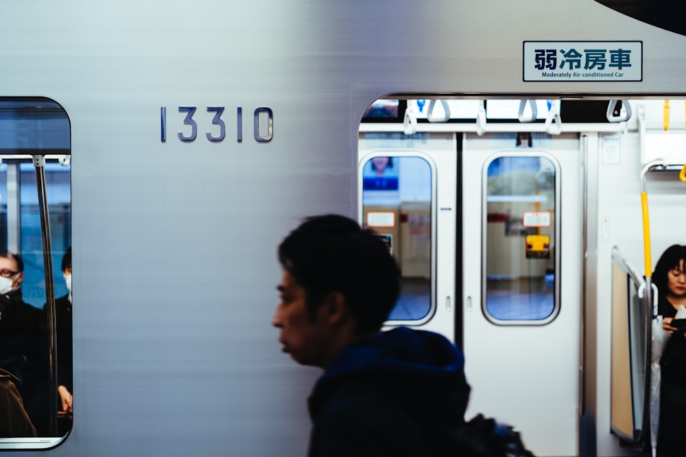 man walking beside train