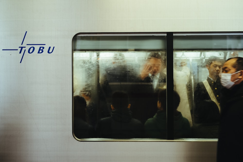 man beside gray train